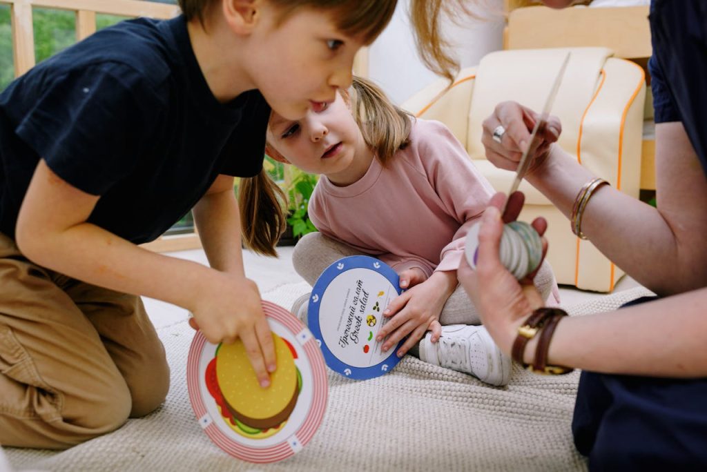 Children playing with educational toys in a playroom with a caregiver, fostering creativity and concentration.